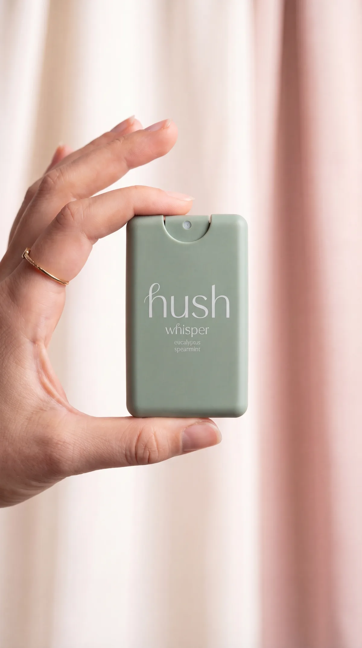 Hush bottle held in hand showing scale