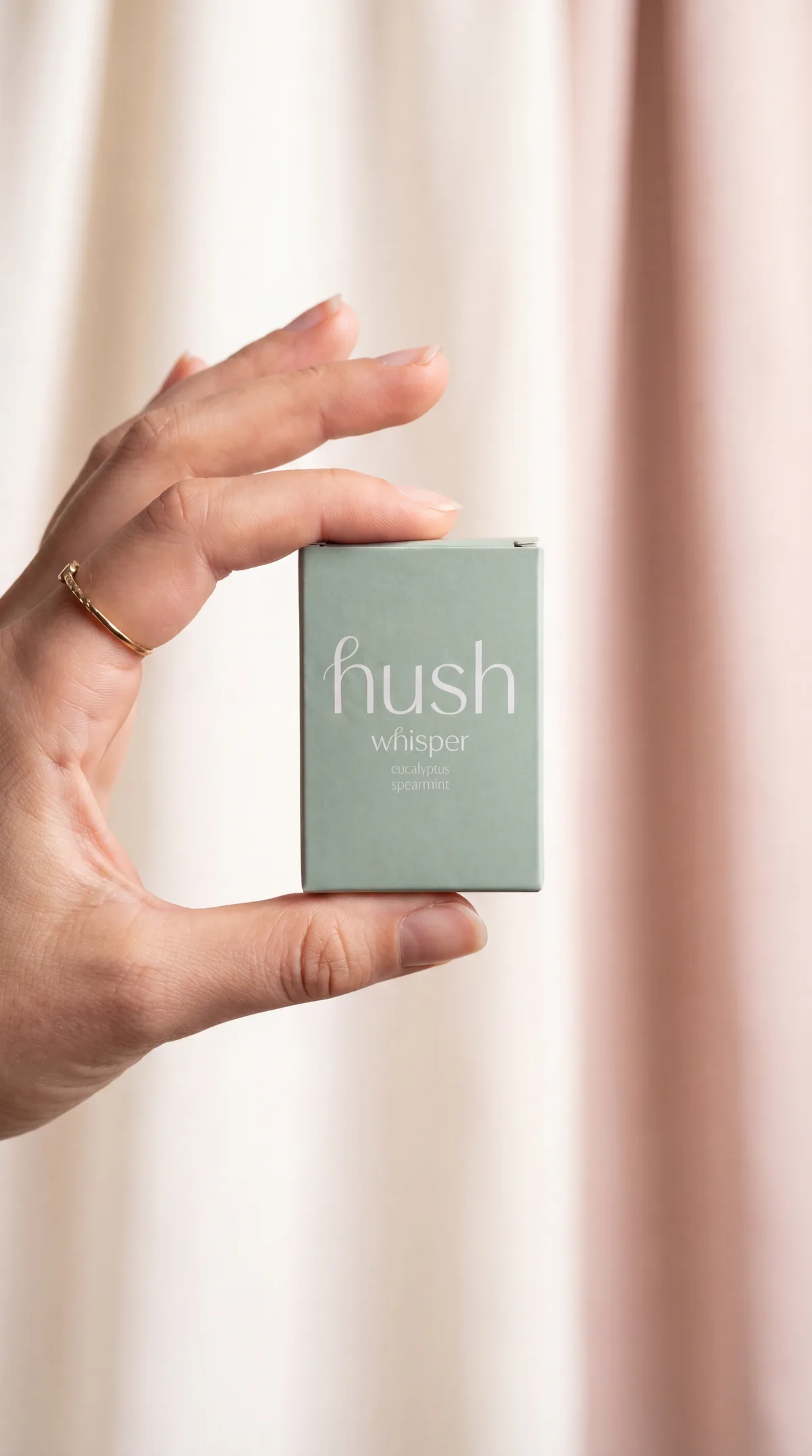 Hush box held between fingers